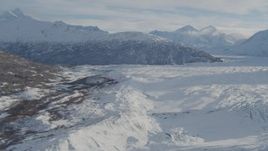 4K aerial stock footage flying along edge of snow covered Knik Glacier toward Chugach Mountains, Alaska Aerial Stock Footage | AK0001_1388