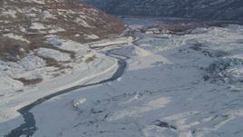 4K aerial stock footage a river near edge of the snow covered Knik Glacier, Alaska Aerial Stock Footage | AK0001_1391