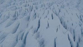 4K aerial stock footage the surface of the cracked, snow covered Knik Glacier, Alaska Aerial Stock Footage | AK0001_1410