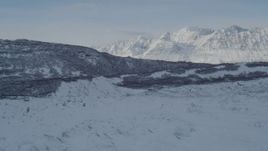 4K aerial stock footage a low ridge bordering the snow covered Knik Glacier, Alaska Aerial Stock Footage | AK0001_1414