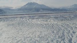 4K aerial stock footage flying over snow covered Knik Glacier, Chugach Mountains in distance, Alaska Aerial Stock Footage | AK0001_1430