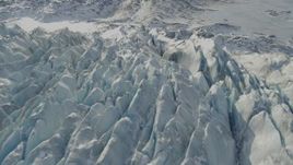 4K aerial stock footage tilt down on jagged, snow covered surface of Knik Glacier, Alaska Aerial Stock Footage | AK0001_1431
