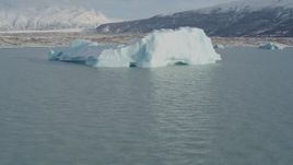 4K aerial stock footage flying by a piece of glacial ice on Inner Lake George, Alaska in snow Aerial Stock Footage | AK0001_1438
