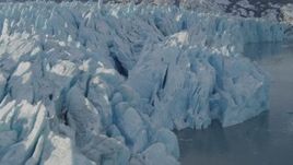 4K aerial stock footage flying along edge of a snow covered glacier on Inner Lake George, Alaska Aerial Stock Footage | AK0001_1447
