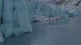 4K aerial stock footage the edge of a snow covered glacier on Inner Lake George, Alaska Aerial Stock Footage | AK0001_1449
