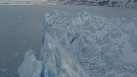 4K aerial stock footage flying along edge of snow covered glacier on Inner Lake George, Alaska Aerial Stock Footage | AK0001_1456