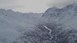 4K aerial stock footage icy river between snow covered ranges in the Chugach Mountains, Alaska Aerial Stock Footage | AK0001_1490