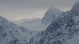 4K aerial stock footage Chugach Mountains and snowy valleys with low clouds, Alaska Aerial Stock Footage | AK0001_1495