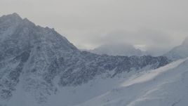 4K aerial stock footage rocky, snow covered mountain ranges and low clouds, Chugach Mountains, Alaska Aerial Stock Footage | AK0001_1500