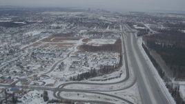 4K aerial stock footage following Glenn Highway, revealing snow covered Downtown Anchorage, Alaska Aerial Stock Footage | AK0001_1515