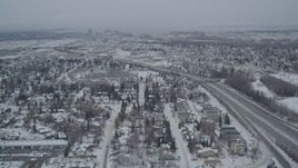 4K aerial stock footage following Glenn Highway, revealing Downtown Anchorage, Alaska in snow Aerial Stock Footage | AK0001_1516