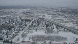4K aerial stock footage fly over snowy neighborhoods, reveal Glenn Highway, Anchorage, Alaska Aerial Stock Footage | AK0001_1517