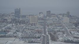 4K aerial stock footage snow covered Downtown Anchorage skyline seen from East 5th Avenue, Alaska Aerial Stock Footage | AK0001_1519