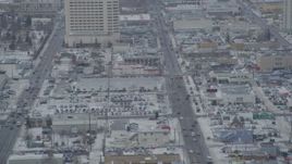 4K aerial stock footage following East 5th Avenue in snow, Downtown Anchorage, Alaska Aerial Stock Footage | AK0001_1520
