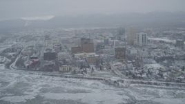 4K aerial stock footage snow covered Downtown Anchorage from shore of the Cook Inlet, Alaska Aerial Stock Footage | AK0001_1523