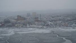4K aerial stock footage flying away from snow covered Downtown Anchorage, Alaska Aerial Stock Footage | AK0001_1525