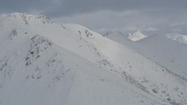 4K aerial stock footage panning across snowy mountain slopes, Chugach Mountains, Alaska Aerial Stock Footage | AK0001_1543