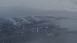 4K aerial stock footage flying through clouds toward snowy Chugach Mountains, Alaska Aerial Stock Footage | AK0001_1551