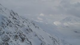 4K aerial stock footage flying by a snowy slope in Chugach Mountains, Alaska Aerial Stock Footage | AK0001_1560