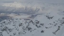4K aerial stock footage flying over snowy mountain ridges toward Butte, Chugach Mountains, Alaska Aerial Stock Footage | AK0001_1567