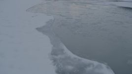 4K aerial stock footage fly over the surface of Knik River and snow covered ice, Alaska Aerial Stock Footage | AK0001_1574