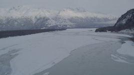 4K aerial stock footage Knik River revealing snow capped Chugach Mountains and riverbank, Alaska Aerial Stock Footage | AK0001_1575