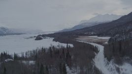 4K aerial stock footage flying over Knik River Road in snow covered Knik River Valley, Alaska Aerial Stock Footage | AK0001_1579