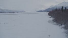 4K aerial stock footage flying low over snow covered, frozen ground in Knik River Valley, Alaska Aerial Stock Footage | AK0001_1587
