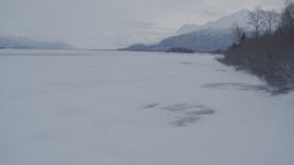 4K aerial stock footage flying over snow covered, frozen ground in Knik River Valley, Alaska Aerial Stock Footage | AK0001_1588