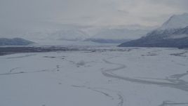 4K aerial stock footage Knik Glacier, Chugach Mountains seen from snowy Knik River Valley, Alaska Aerial Stock Footage | AK0001_1597