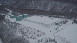 4K aerial stock footage flyby a snow covered warehouse building, Chugiak, Alaska Aerial Stock Footage | AK0001_1615