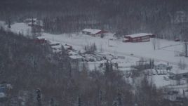4K aerial stock footage snow covered shops on Old Glenn Highway, Chugiak, Alaska Aerial Stock Footage | AK0001_1624