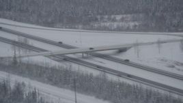 4K aerial stock footage cars on Glenn Highway past D Street overpass, Anchorage, Alaska in snow Aerial Stock Footage | AK0001_1640