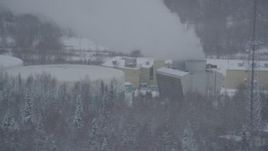 4K aerial stock footage passing a power plant in Anchorage, Alaska in snow Aerial Stock Footage | AK0001_1642