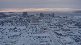 4K aerial stock footage flying over snow covered Downtown Anchorage at twilight, Alaska Aerial Stock Footage | AK0001_1651