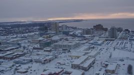 4K aerial stock footage flying over snow covered Downtown Anchorage at twilight, Alaska Aerial Stock Footage | AK0001_1652