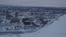 4K aerial stock footage snowy Downtown Anchorage, flying over shore of Cook Inlet at twilight, Alaska Aerial Stock Footage | AK0001_1654