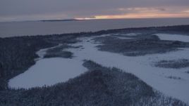 4K aerial stock footage Fire Island seen from snow covered Point MacKenzie at twilight, Alaska Aerial Stock Footage | AK0001_1664