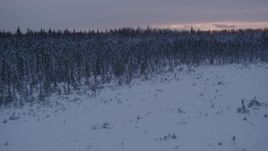 4K aerial stock footage flying low over frozen, snowy ground at sunset, Point MacKenzie, Alaska Aerial Stock Footage | AK0001_1672
