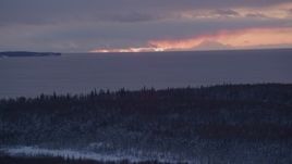 4K aerial stock footage twilight lit clouds seen from snow covered Point MacKenzie, Alaska Aerial Stock Footage | AK0001_1685