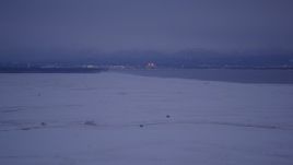 4K aerial stock footage Downtown Anchorage seen from snowy Point MacKenzie, Alaska, twilight Aerial Stock Footage | AK0001_1713