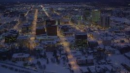 4K aerial stock footage fly over icy shore of Cook Inlet and snowy Downtown Anchorage, Alaska, night Aerial Stock Footage | AK0001_1721