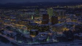 4K aerial stock footage orbiting snow covered Downtown Anchorage at night, Alaska Aerial Stock Footage | AK0001_1723