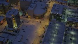 4K aerial stock footage following West 6th Avenue in snow covered Downtown Anchorage at night, Alaska Aerial Stock Footage | AK0001_1724
