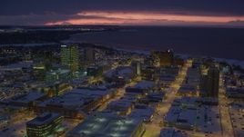 4K aerial stock footage flying over snow covered Downtown Anchorage at night, Alaska Aerial Stock Footage | AK0001_1726