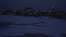 4K aerial stock footage flying along icy shore of Cook Inlet, snowy Downtown Anchorage, Alaska, night Aerial Stock Footage | AK0001_1727
