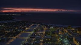 4K aerial stock footage sunset lit horizon seen from snow covered Downtown Anchorage at night, Alaska Aerial Stock Footage | AK0001_1731