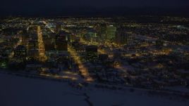 4K aerial stock footage snowy Downtown Anchorage buildings near the shore of Cook Inlet, Alaska, night Aerial Stock Footage | AK0001_1734