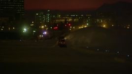4K aerial stock footage a snow plow clearing snow at night, Anchorage, Alaska Aerial Stock Footage | AK0001_1737