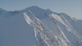 Following a snow covered ridge in the Chugach Mountains, Alaska Aerial Stock Footage | AK0001_1748